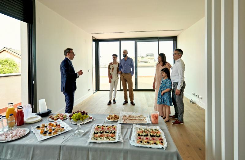Real Estate Agent and Prospective Buyers at Open House