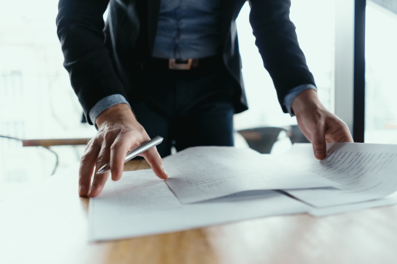 Successful business man signing documents